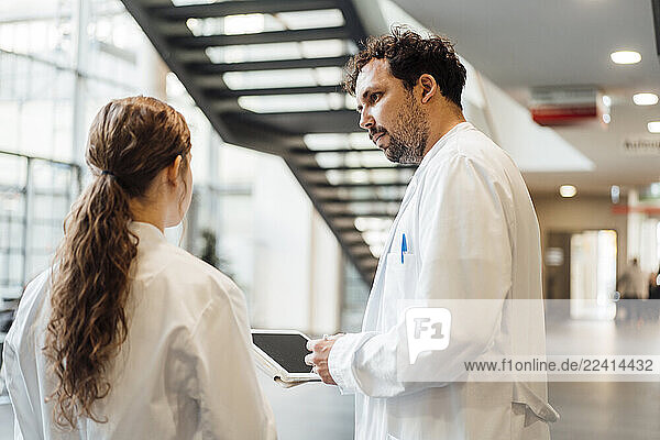 Doctors consulting in a hospital corridor