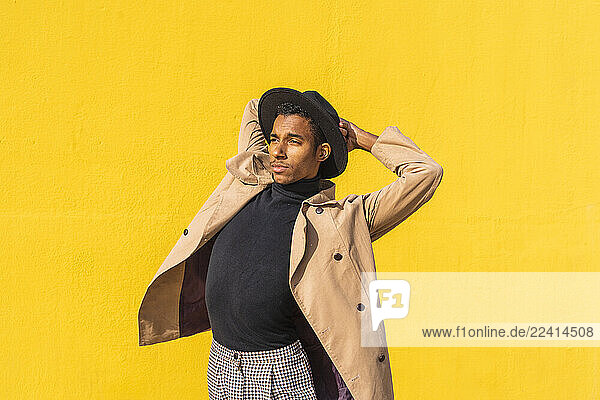 Young dancer performing in front of yellow wall