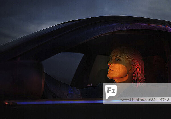 Woman driving a car at sunset with a futuristic feel