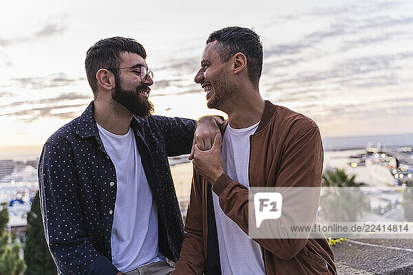 Happy affectionate gay couple on lookout above the city  Barcelona  Spain