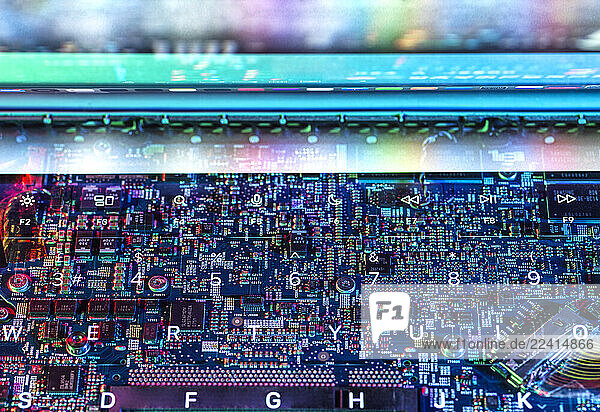 Close-up of a colorful circuit board and keyboard representing technology and artificial intelligence