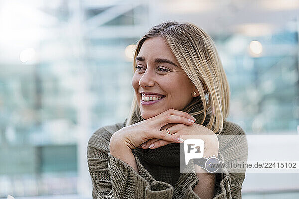 Portrait of a smiling young woman looking away