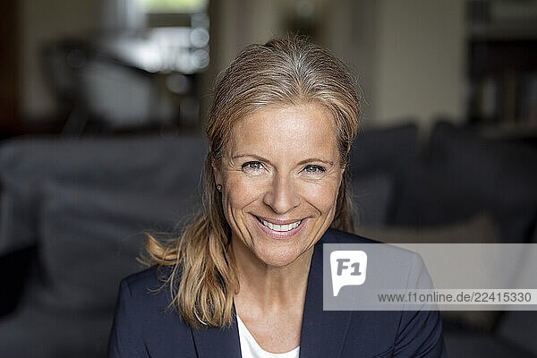 Portrait of smiling mature businesswoman at home
