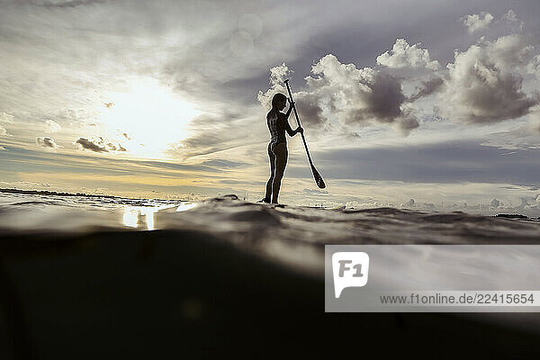 Female SUP surfer at sunset  Bali  Indonesia