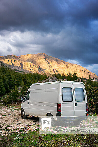Camper van parked near a mountain road enjoying the landscape