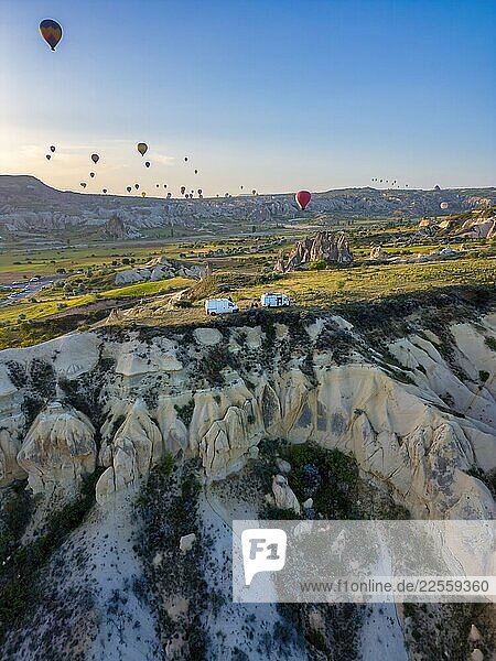 Camper vans drone view with hot air balloons flying in Cappadocia