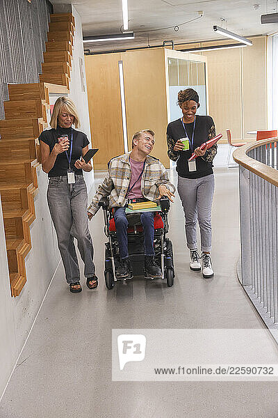 Man in wheelchair and coworkers in office