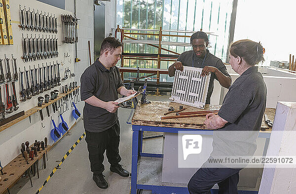 Disabled men and woman at workshop