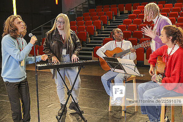 Persons with disabilities rehearsing music on stage