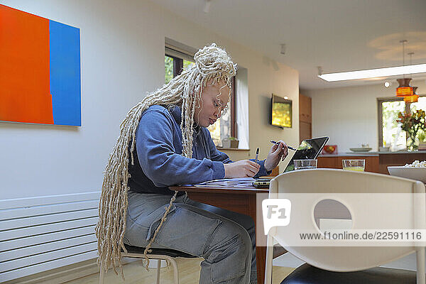 Woman using digital tablet at home