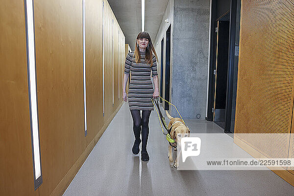 Blind woman with guide dog in office
