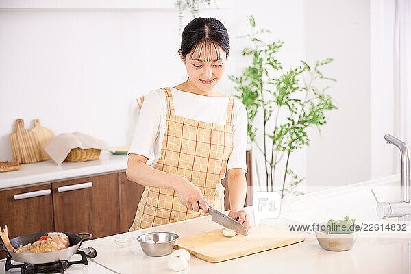 Young Japanese woman cooking at home