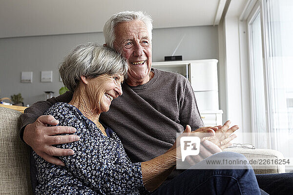 Happy couple embracing at home in a moment of closeness and trust