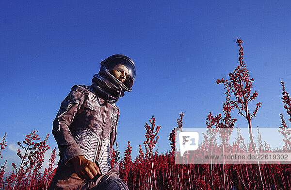Astronaut in a spacesuit exploring a surreal red landscape
