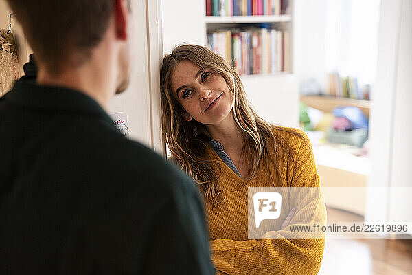 Couple communicating happily at home in a cozy living room
