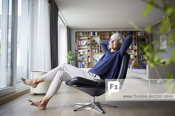 Senior woman relaxing in a modern living room at home