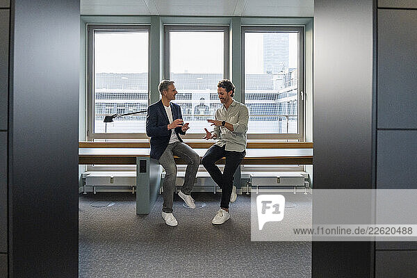 Two men having a business discussion in a modern office setting