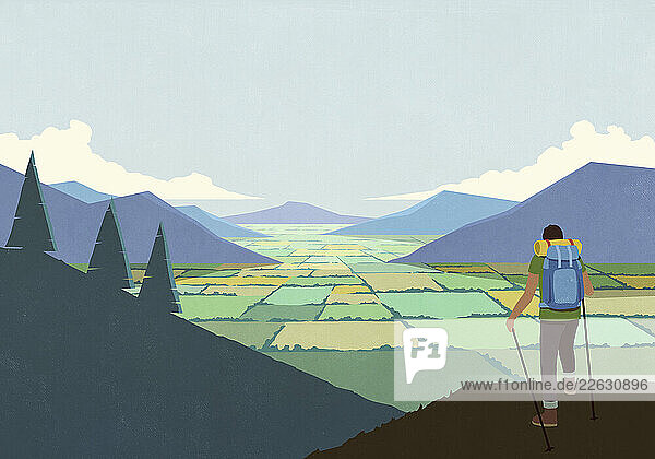 Man backpacking in nature  looking at scenic mountain valley landscape view