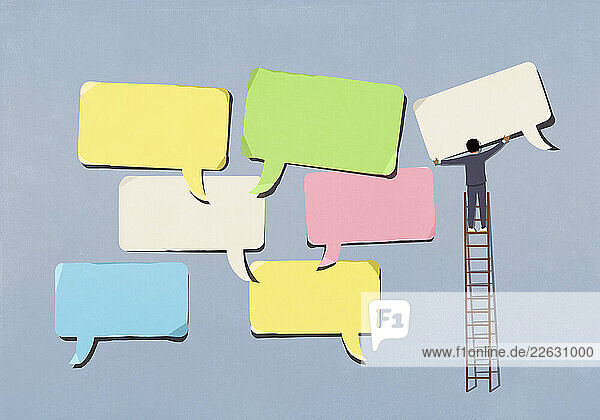 Businessman on ladder arranging large  multicolored speech bubbles on blue background