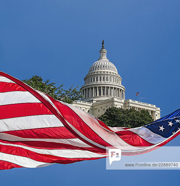 Composite image of Capital Building with flying American Flag