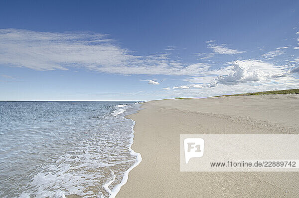 Ocean waves on empty sandy beach