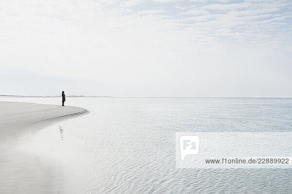 Woman standing at water s edge