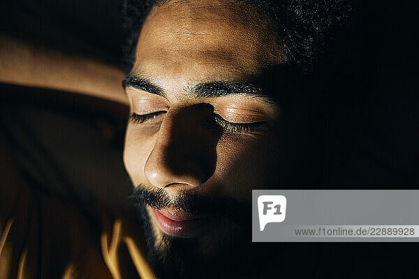 Close-up of sunlight shining on man s face