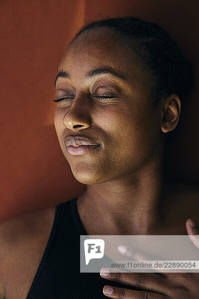 Directly above close-up shot of woman lying on exercise mat with eyes closed