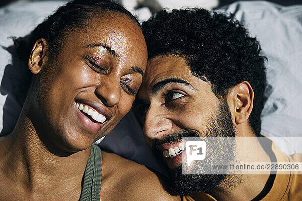 Happy man enjoying leisure time with girlfriend at home