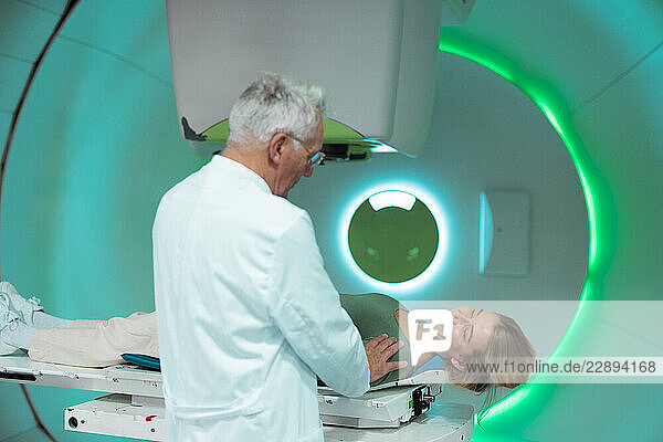 Doctor and patient in a radiology treatment room with advanced medical equipment