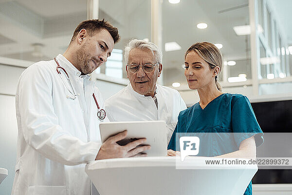 Medical team consulting in a doctor s office with a tablet