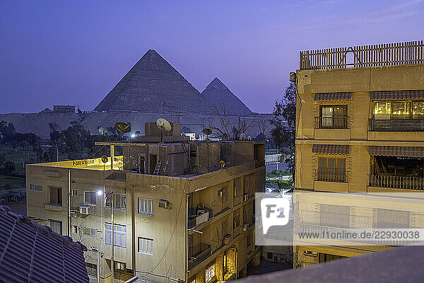 View of the Giza Pyramids from rooftop terrace at dusk  Giza  Cairo  Egypt  Africa