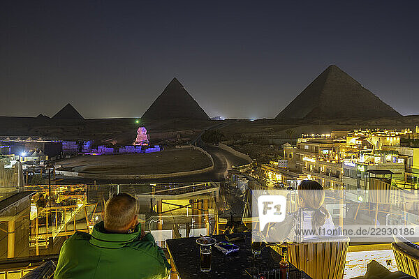 View of Giza Pyramids from rooftop terrace during light show  Cairo  Egypt  Africa