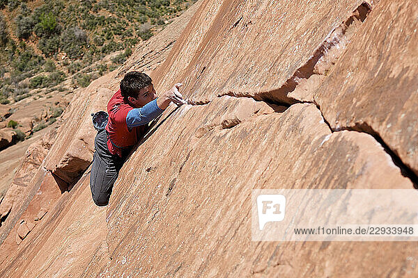 A man rock climbing in Zion National Park  UT.