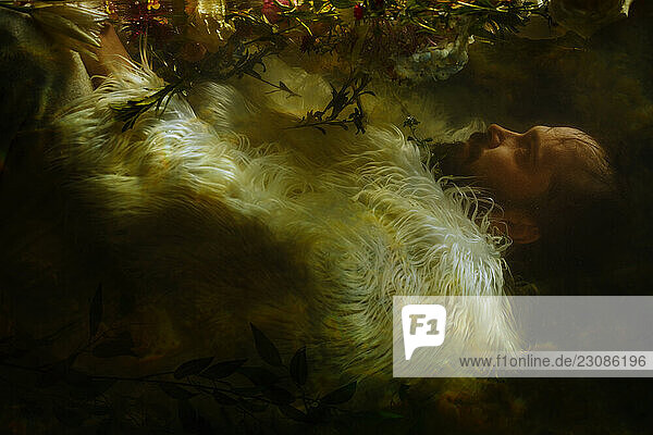 Bearded man in furry outfit floating underwater