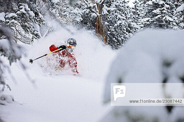 A man skiing fresh powder on a stormy day.