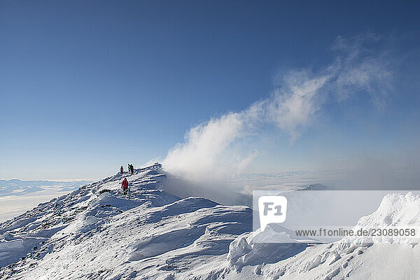 Scientists walk around the crater rim of Mount Erebus Antarctcia.