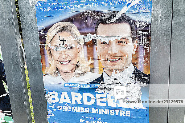 France  vandalized poster Marine Le Pen  with swastika on forehead and Jordan Bardella. Legislative elections  2024.