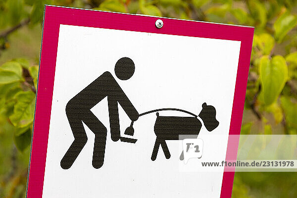 Signs asking you to pick up dog droppings